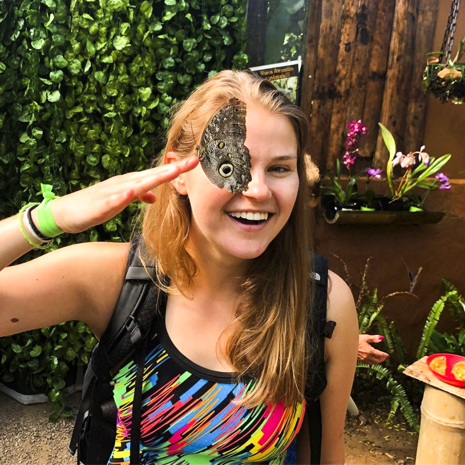 Travel to Ecuador to see natural wonders from the Andes mountains to the Amazon basin and the Galápagos Islands. Visit the Charles Darwin Research Station to learn about conservation efforts and receive a community service certificate upon program completion. Student with butterfly