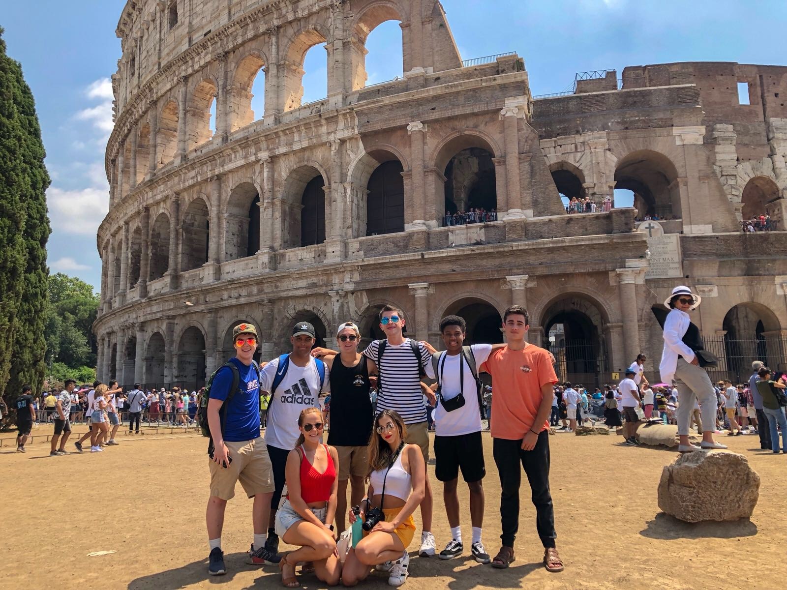 Study food culture in Italy, learn how to make traditional Italian dishes, take in the historic sites of Rome, and wander along the canals of Venice. Receive language and culinary training from renowned institutions. Summer study abroad in Italy, students in front of the Colosseum