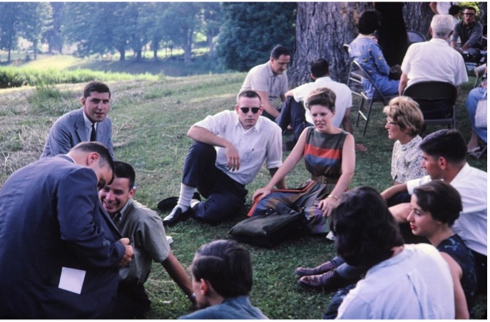 India 1962 group during orientation in Vermont, sitting together on grass